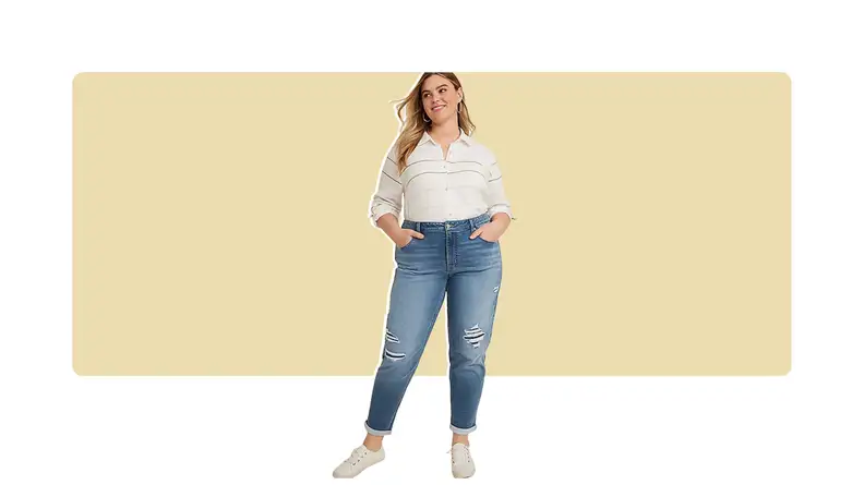A model wearing cropped blue jeans and a striped white top.