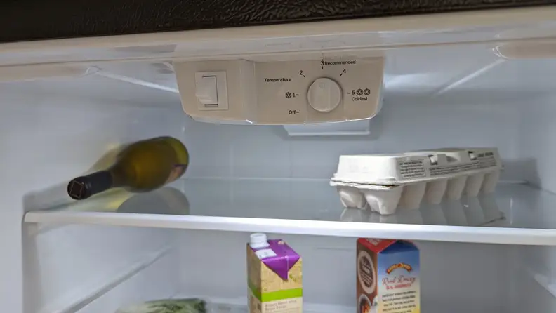 A close-up of the fridge's control panel, located in the top center of the fridge compartment.