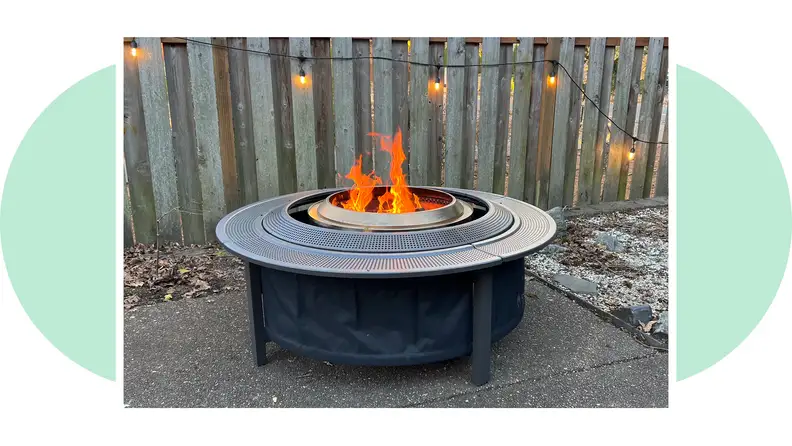 Side view of the Solo Stove Surround with a flame burning in the firepit.