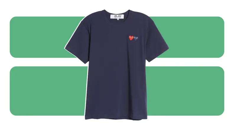 A navy t-shirt with embroidered heart emblems on the chest.