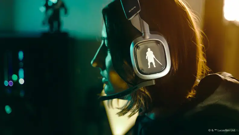 A logitech gaming headset in grey with Mandalorian-themed side cutouts