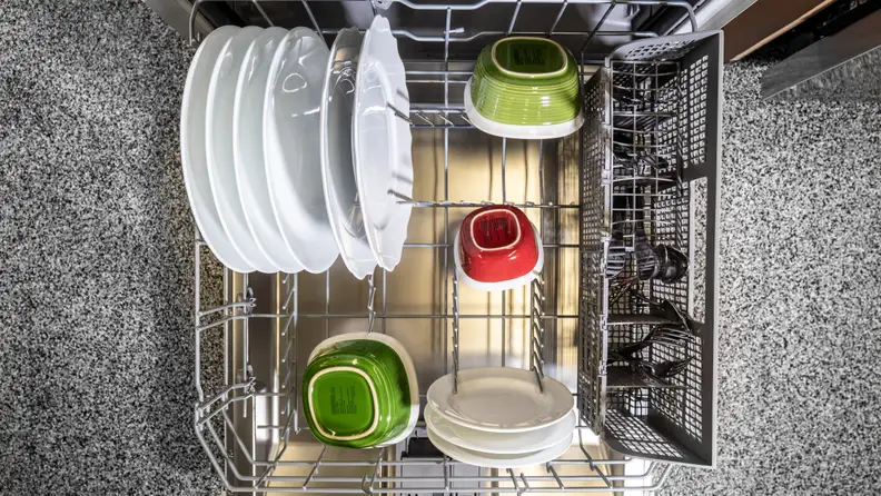 The lower rack has a set of foldable tines and a removable cutlery basket.