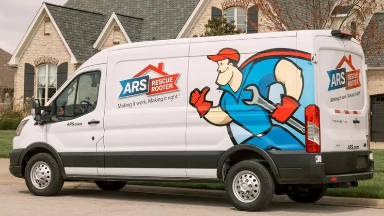 Branded service van parked in front of a brick home