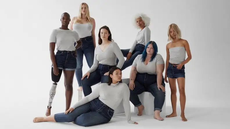 women standing in a group together in front of white backdrop