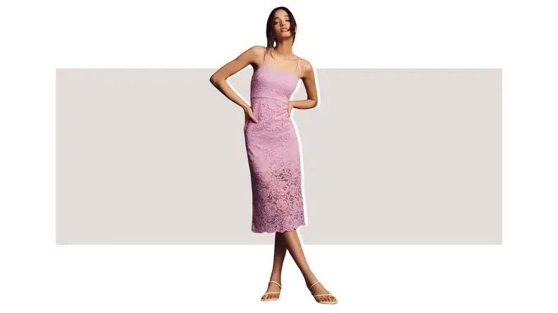 A model wearing a lilac-colored midi dress made from lace fabric.