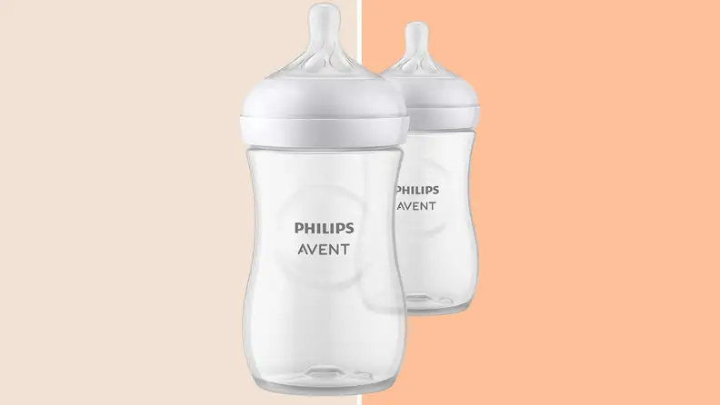 The Philips Avent Natural baby bottle against a two tone orange background.