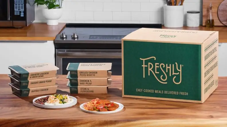 A box of Freshly pre-made meals sitting on a countertop.