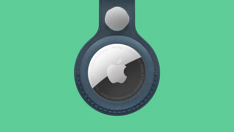 Apple Airtag in leather loop on colored background