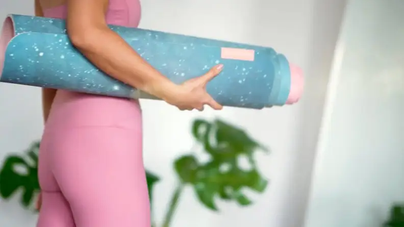 Image of person carrying a yoga mat
