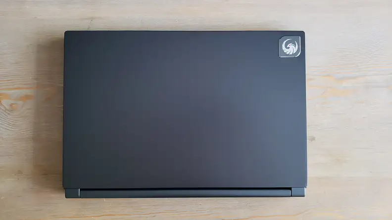 A closed laptop on a wooden coffee table