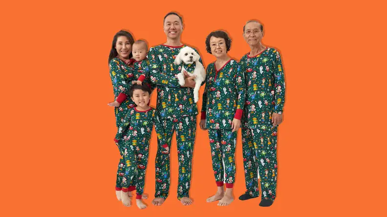 A family wearing Little Sleepies Disney Christmas Party matching family Christmas Pajamas.
