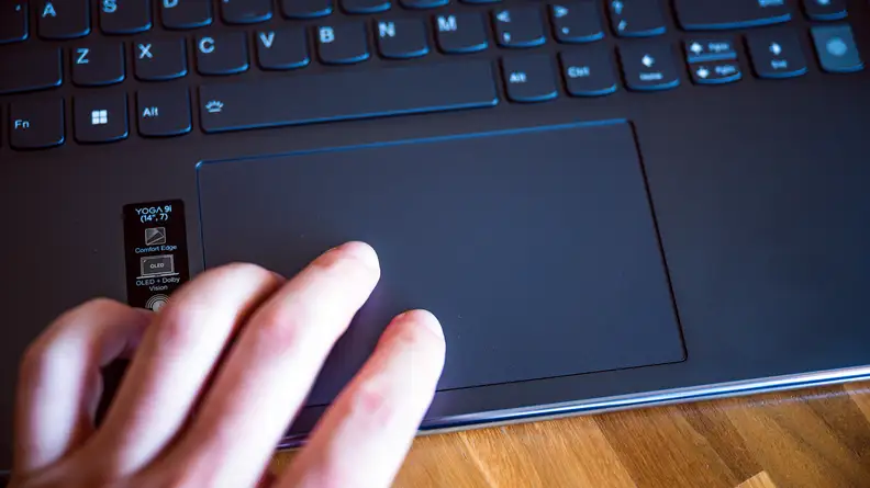 Someone slides their finger across the trackpad