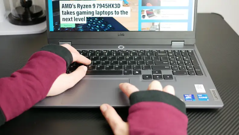 A pair of hands typing on the laptop's keyboard.
