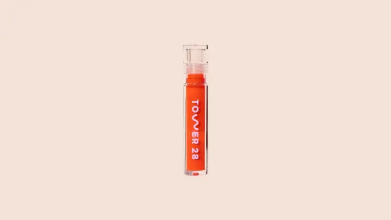 The Shine-On Lip Jelly in front of a background.