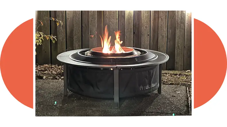 Side view of the Solo Stove Surround with a flame burning in the firepit.