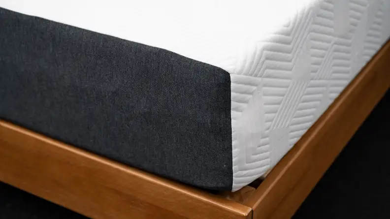 the corner of the lucid mattress with gray fabric on one side and white on the other
