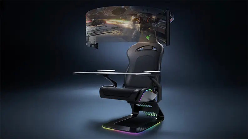 A retractable display screen encircles a Razer gaming chair for bleeding-edge immersion. There are colored lights along the edges of the chair.
