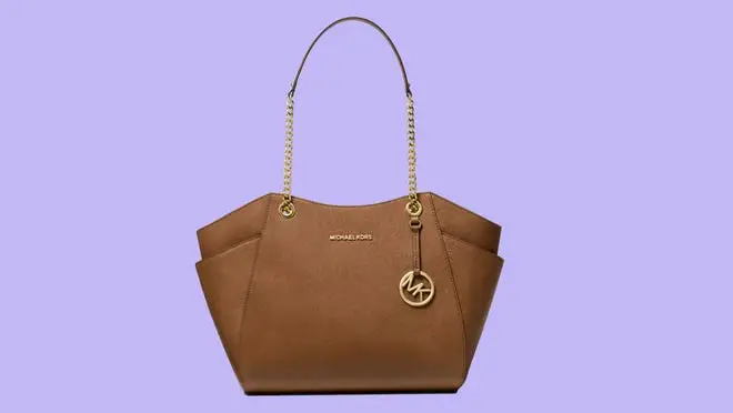 Brown leather bag against purple background