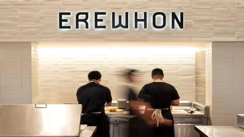 Staff working behind the counter under an Erewhon sign