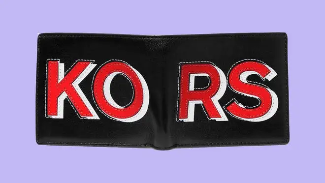 Black wallet with red text that says 'Kors' against a purple background