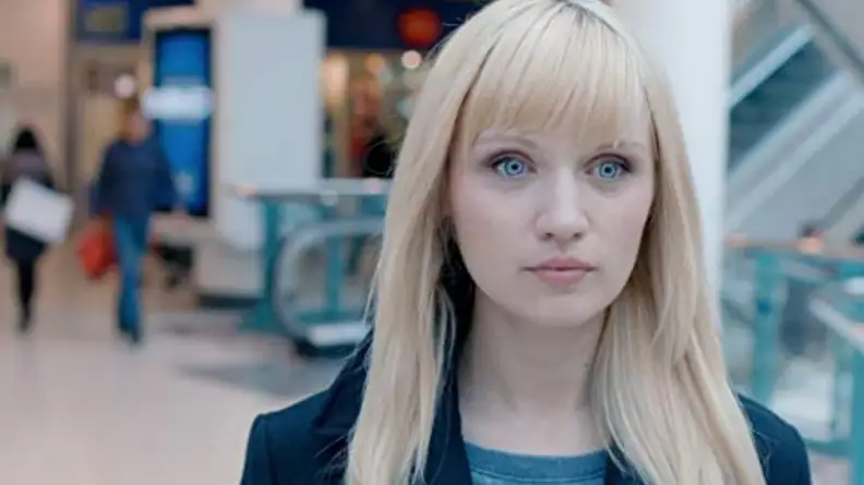An image of one of the synths from Humans walking forward, with her eyes wide open.