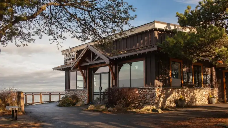 Exterior of a wooden coffee shop overlooking the water