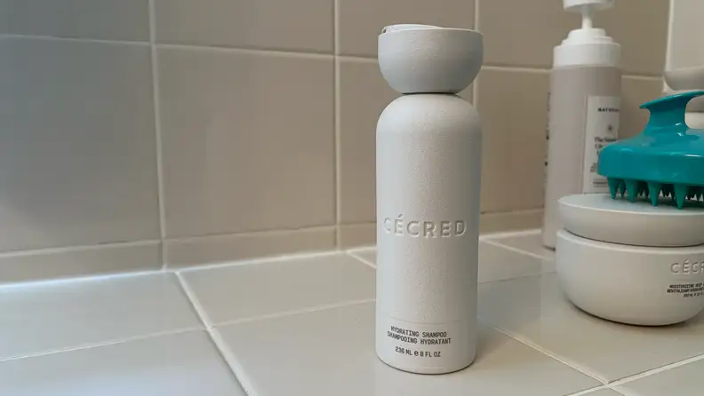 A bottle of Cecred shampoo on a countertop.