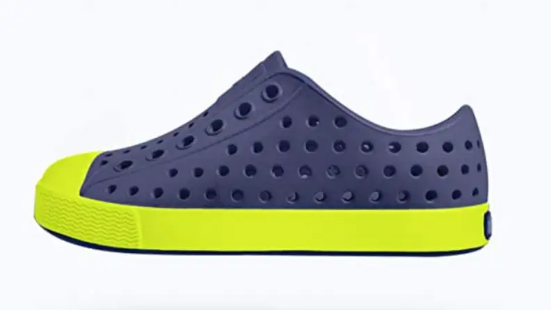 A blue Natives shoe with a bright green sole.