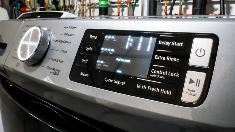 The control panel of the Maytag MHW6630HC front-load washer. Next to a giant cycle selection dial that reads, in all-caps, "EXTRA POWER," is a touch panel with more nuanced controls like temperature and water level selection.