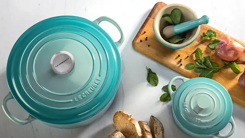 A Le Creuset dutch oven and other accessories, available on the QVC website.