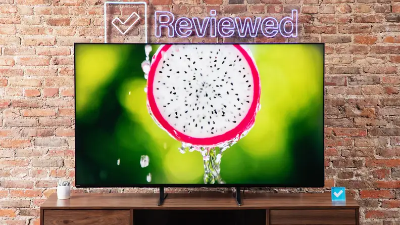 A Sony Bravia 9 Mini-LED TV sitting on a wood entertainment center, with a dragon fruit cut in half on the screen.