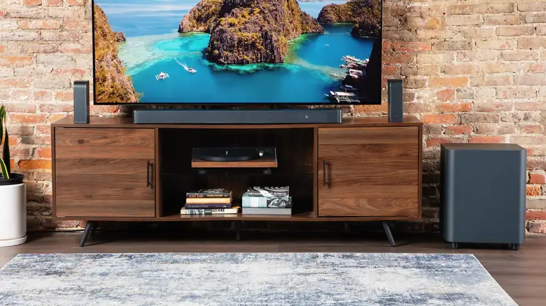 A TV entertainment center featuring the JBL Bar 1300X on the TV console center.