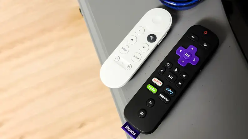 The Google Chromecast with Google TV remote next to the Roku remote