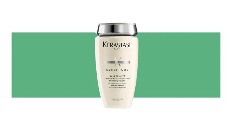 Kerastase hair product on a green background.