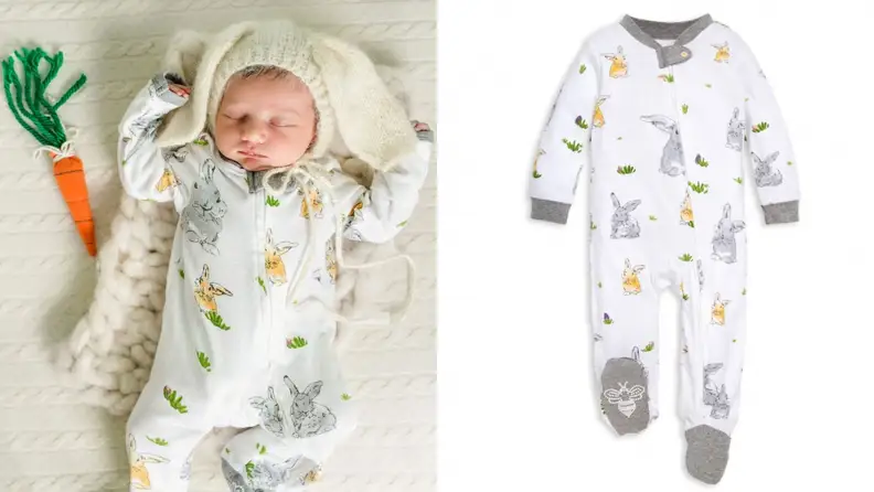 A sleeping baby next to a hand-knit carrots