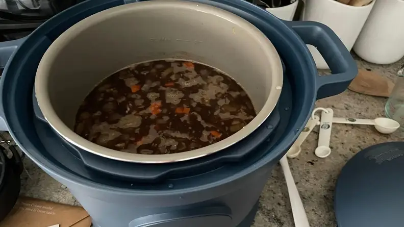 Stew cooking within inner pot of the Our Place Dream Cooker.