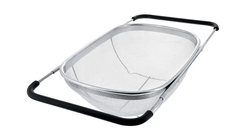 A stainless steel over the sink colander on a white background.