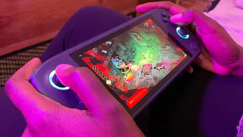 Looking at a woman playing a handheld gaming console