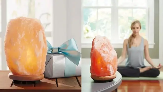On left, pink Himalayan salt lamp next to blue gift box. On right, person doing yoga behind pink Himalayan salt lamp.