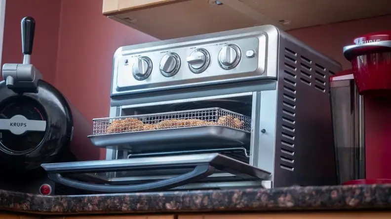 Air fryer toaster oven sitting on counter top.