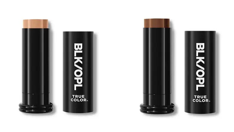 On the left, the Black Opal True Color Stick Foundation SPF 15 has its cap off to expose a tan-colored cream foundation on a white background. On the right, the same foundation stick is pictured but with a dark brown foundation in the roll-up cylinder.