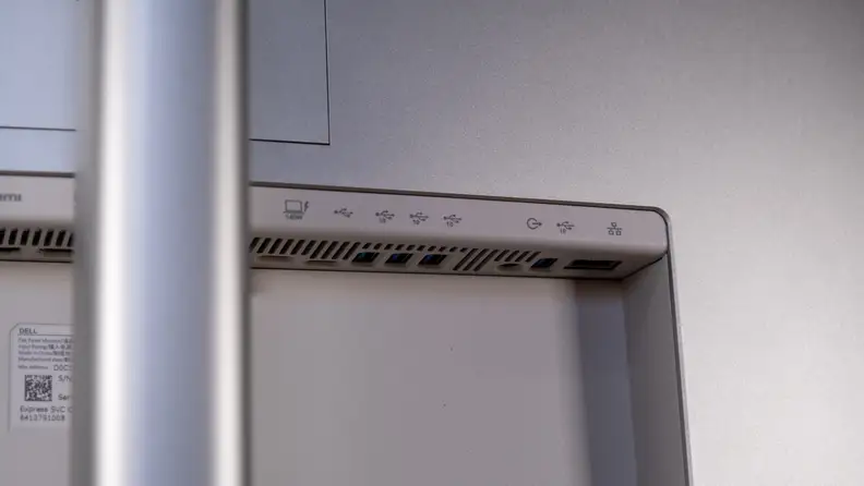 Close-up of the back of a Dell monitor, showing multiple USB ports, an Ethernet port, and power input labels.