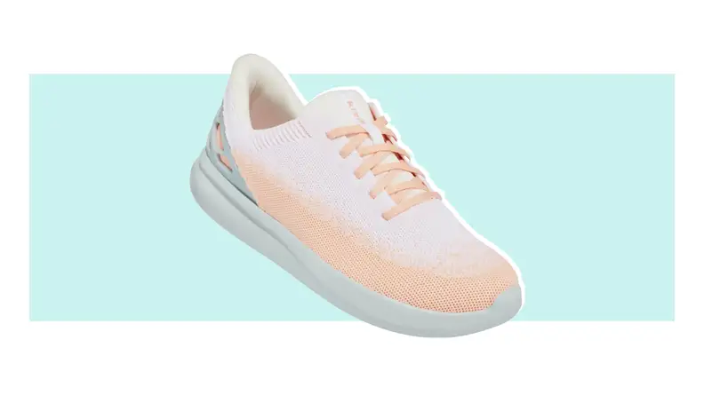A single Kizik shoe in light peach and white positioned with the front tilted downward.