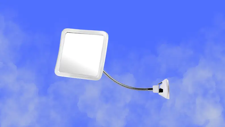 A shower mirror sits on a steamy blue background background
