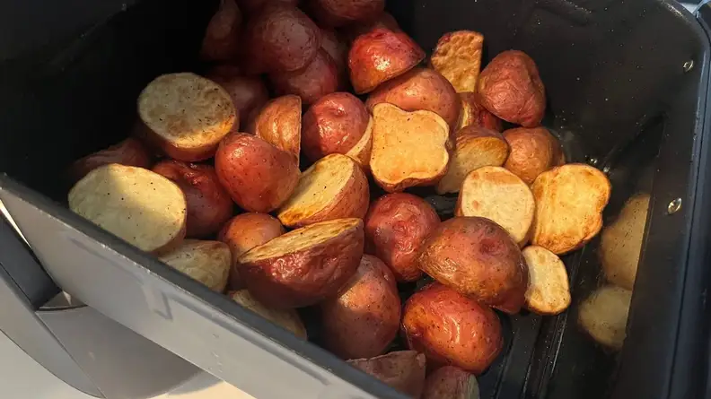A batch of roasted red potatoes inside the Midea air fryer basket