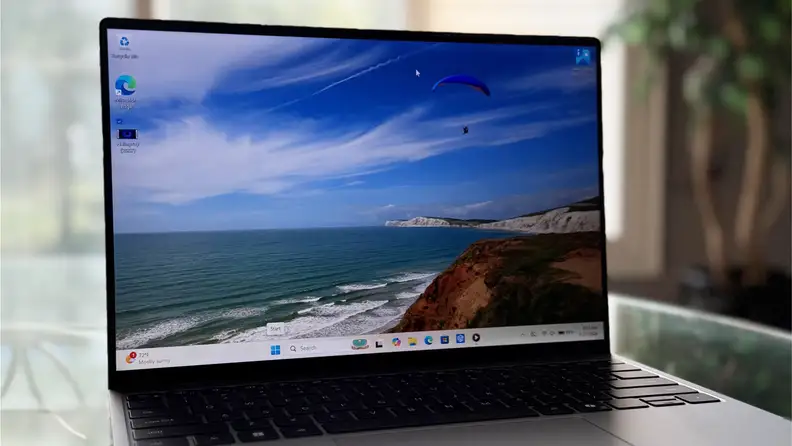Dell XPS 13 showing coastal scene on display.