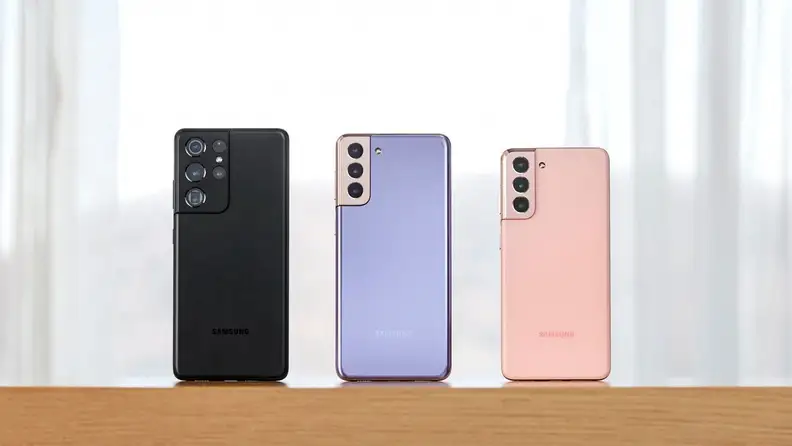 A black, purple, and pink phones next to each other