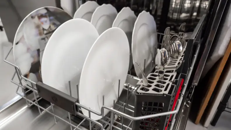 A close-up of the GE Profile PDP715SBNTS dishwasher's lower rack, loaded with dishes.