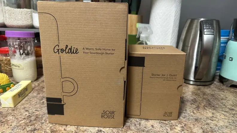 The cardboard box the Goldie comes in next to a box for a jar from Sourhouse.