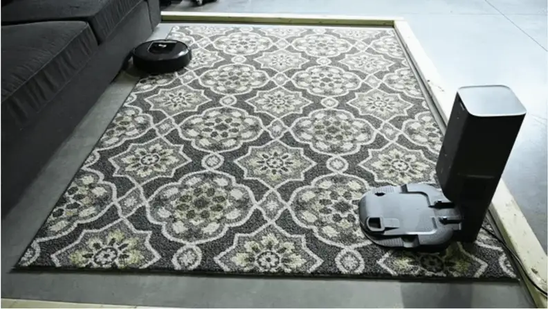 The iRobot i7+ races across the test area to try to clean up 100 pine needles.